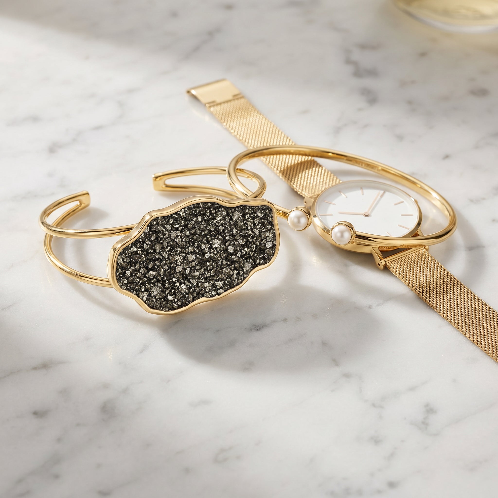 Two gold bracelets on a marble surface|Purplee Store