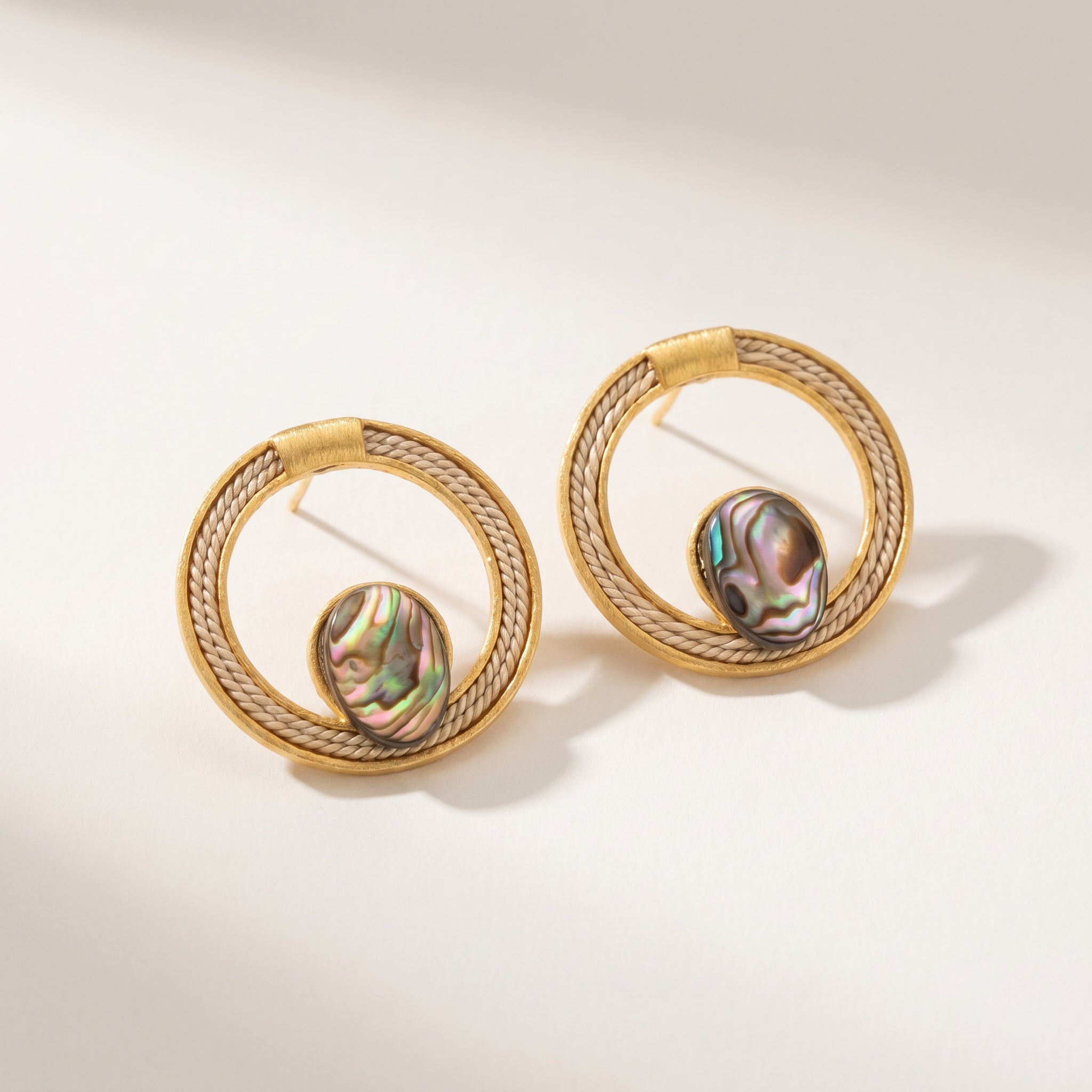 Pair of Buriti Statement Abrya Earrings with central gemstones on a light background.Purplee Store