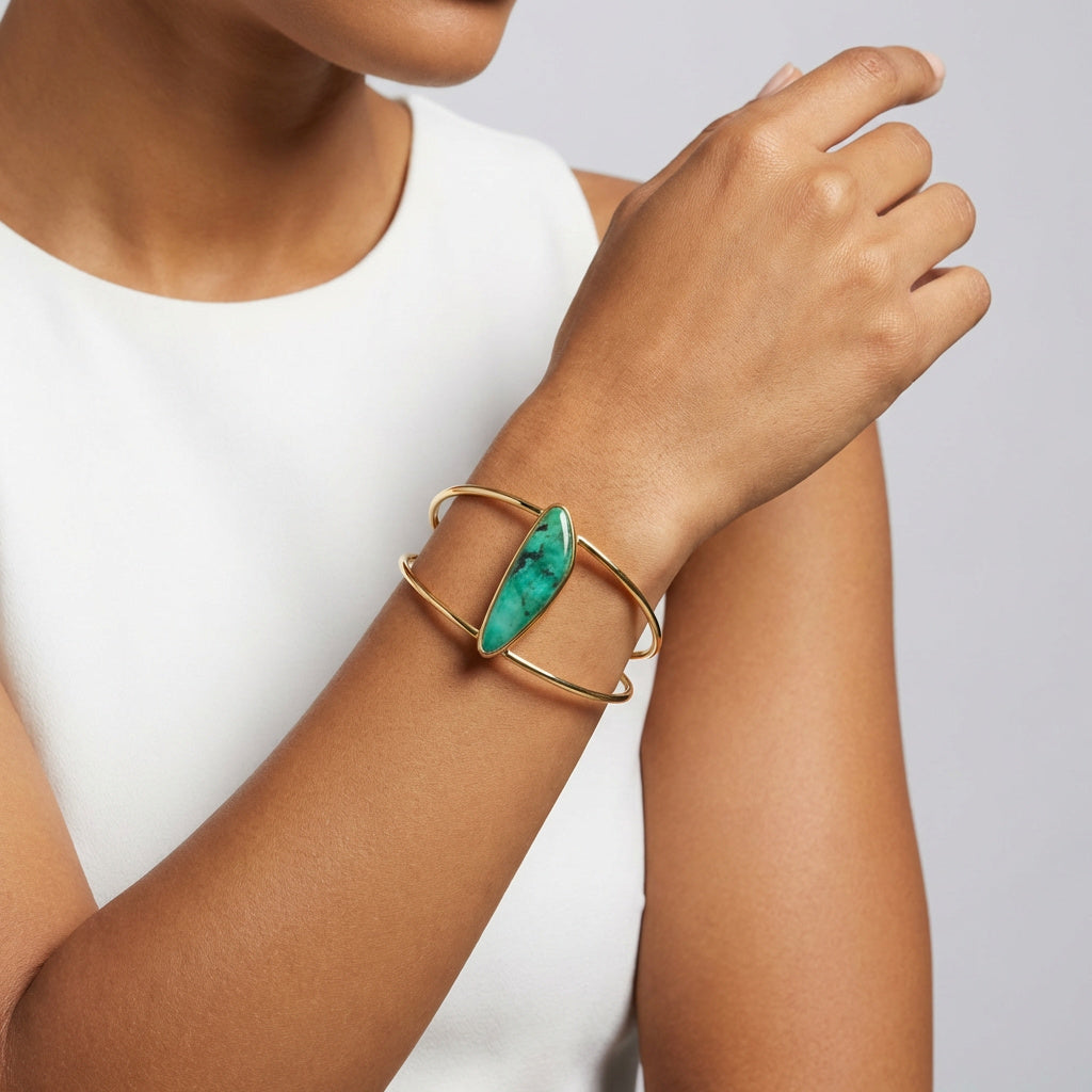 Purplee Store ELAN Emerald Sculptural Cuff on a wrist against a white background