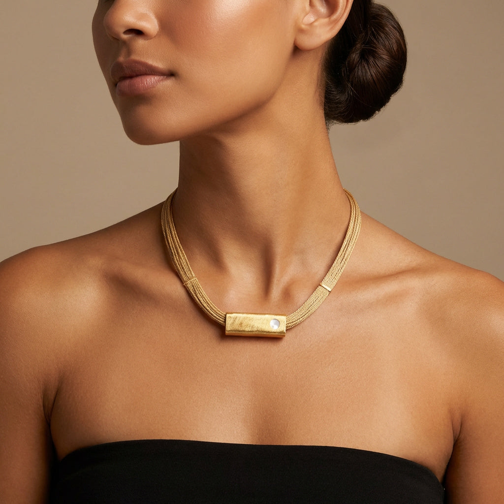 Woman wearing a Handcrafted Buriti Orvellia Necklace with Natural Stones and 18k Gold Mother Pearl on a neutral background. Purplee Store
