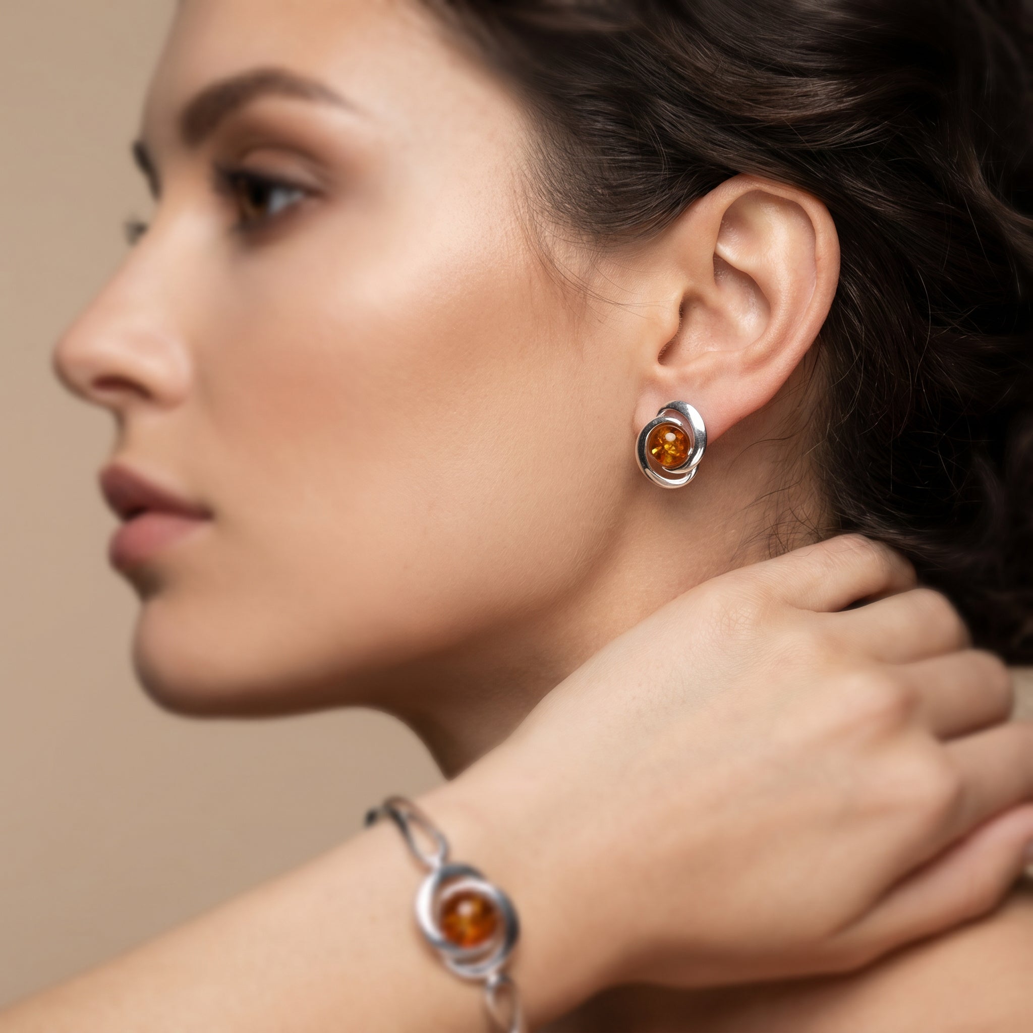 Close-up of a woman wearing Amber Glow Round 925 Silver Drops|Purplee Store against a beige background