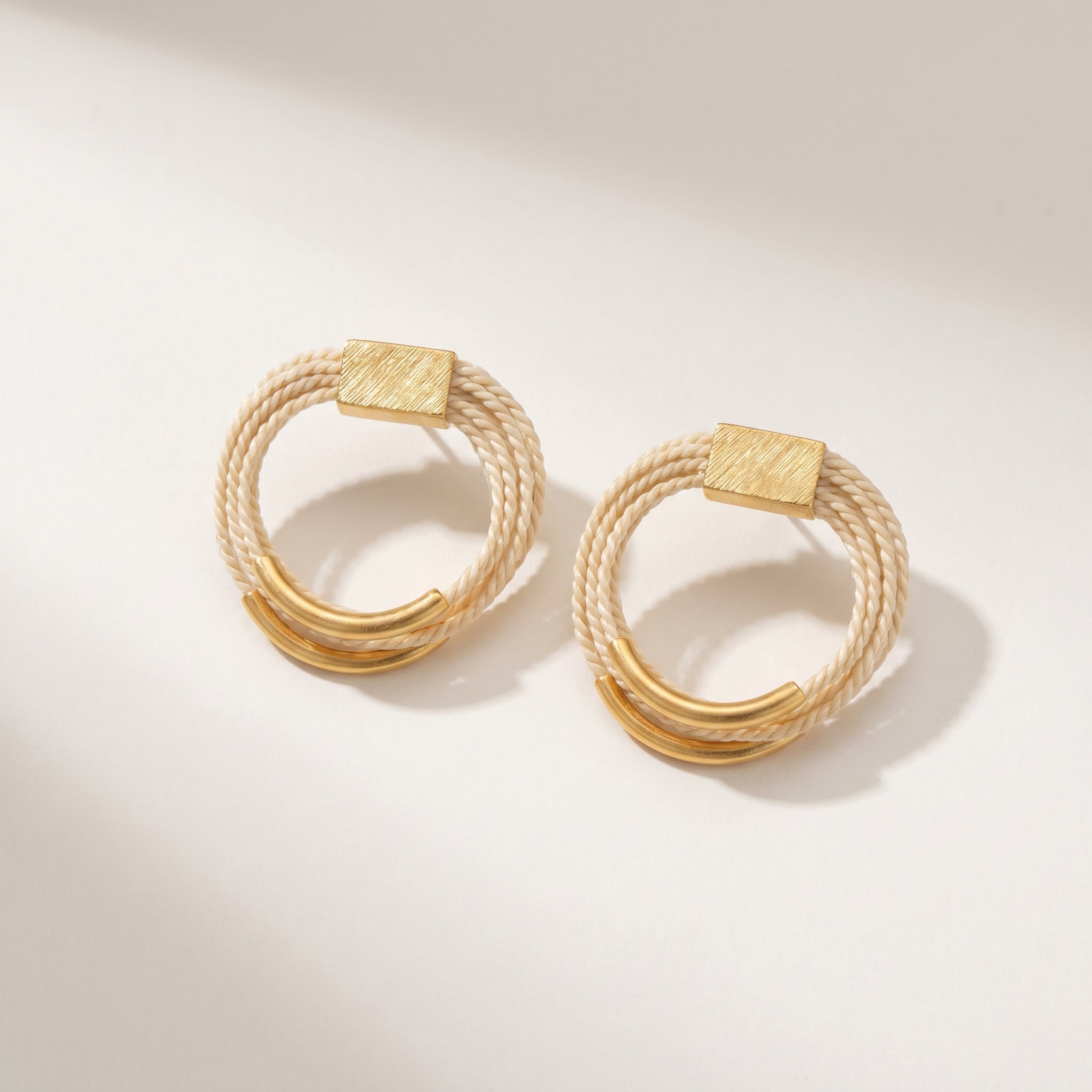 Pair of Buriti Artisanal Elarin Earrings  on a light background.Purplee Store
