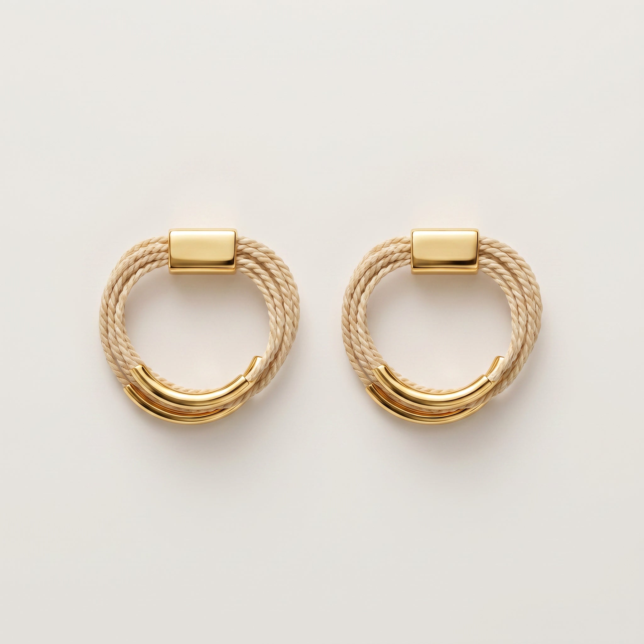 Pair of Buriti Artisanal Elarin Earrings  with braided design on a light background.Purplee Store
