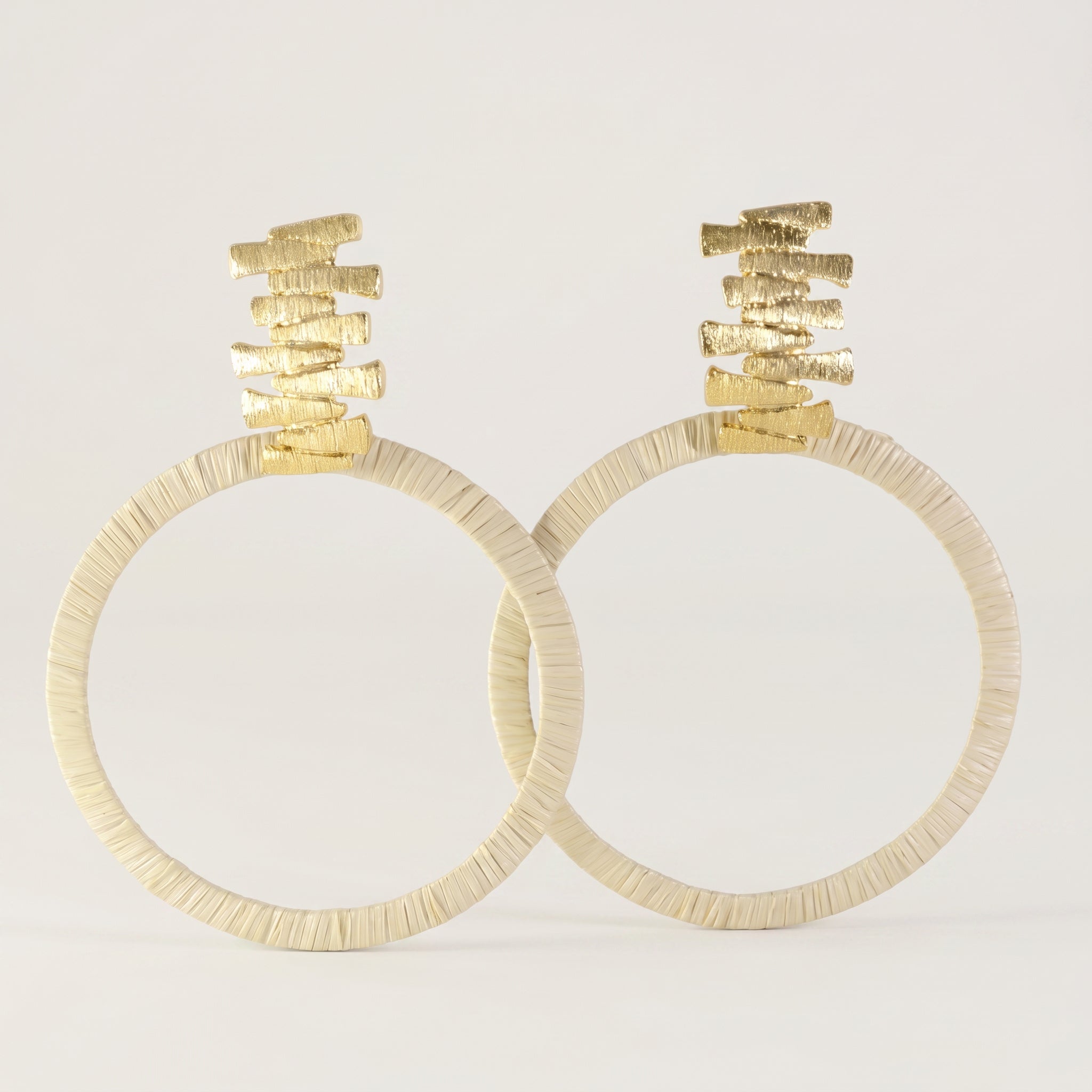 Purplee Store Buriti Sculptural Velune Earrings with textured tops on a light gray background