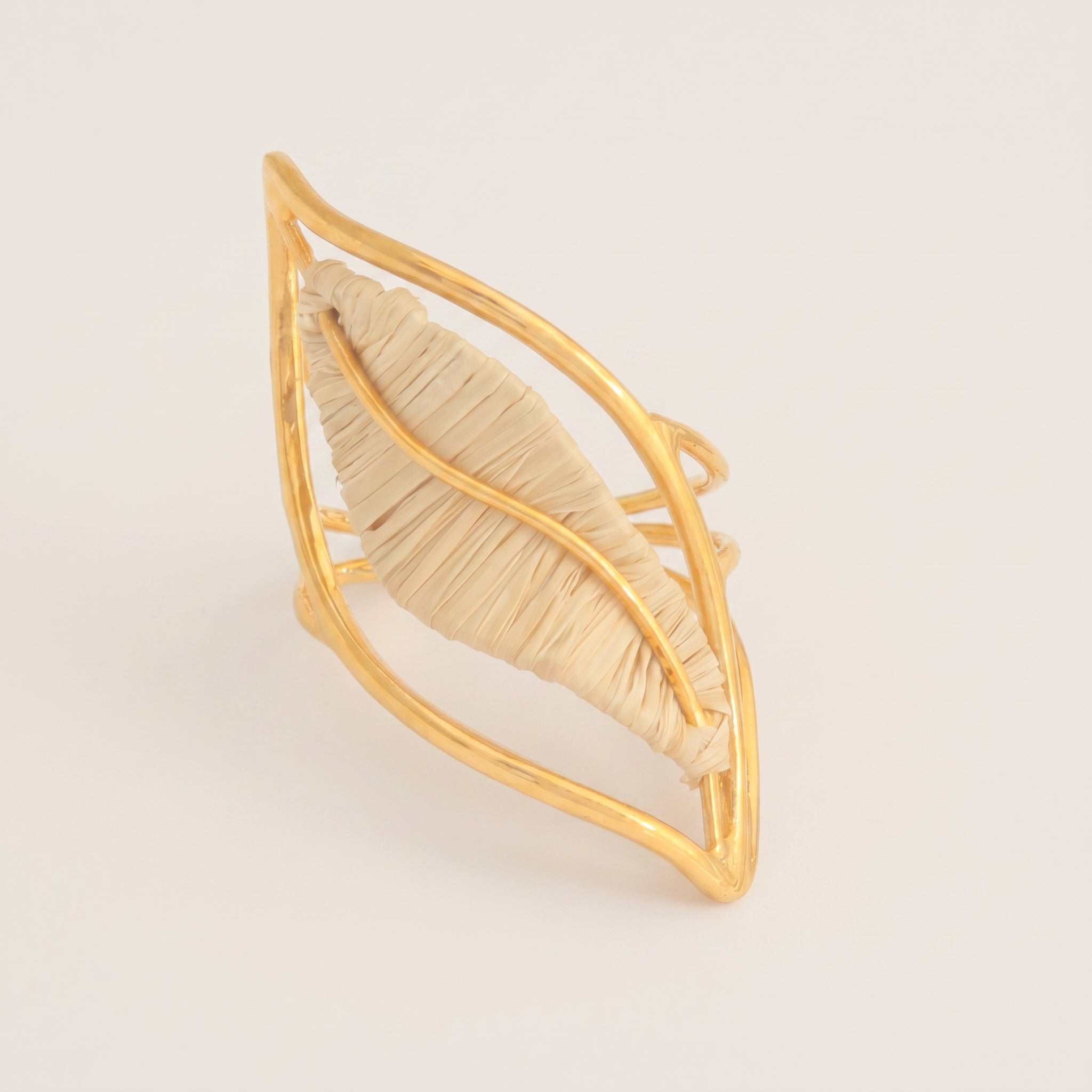 Purplee Store Gold leaf-shaped ring on a light beige background