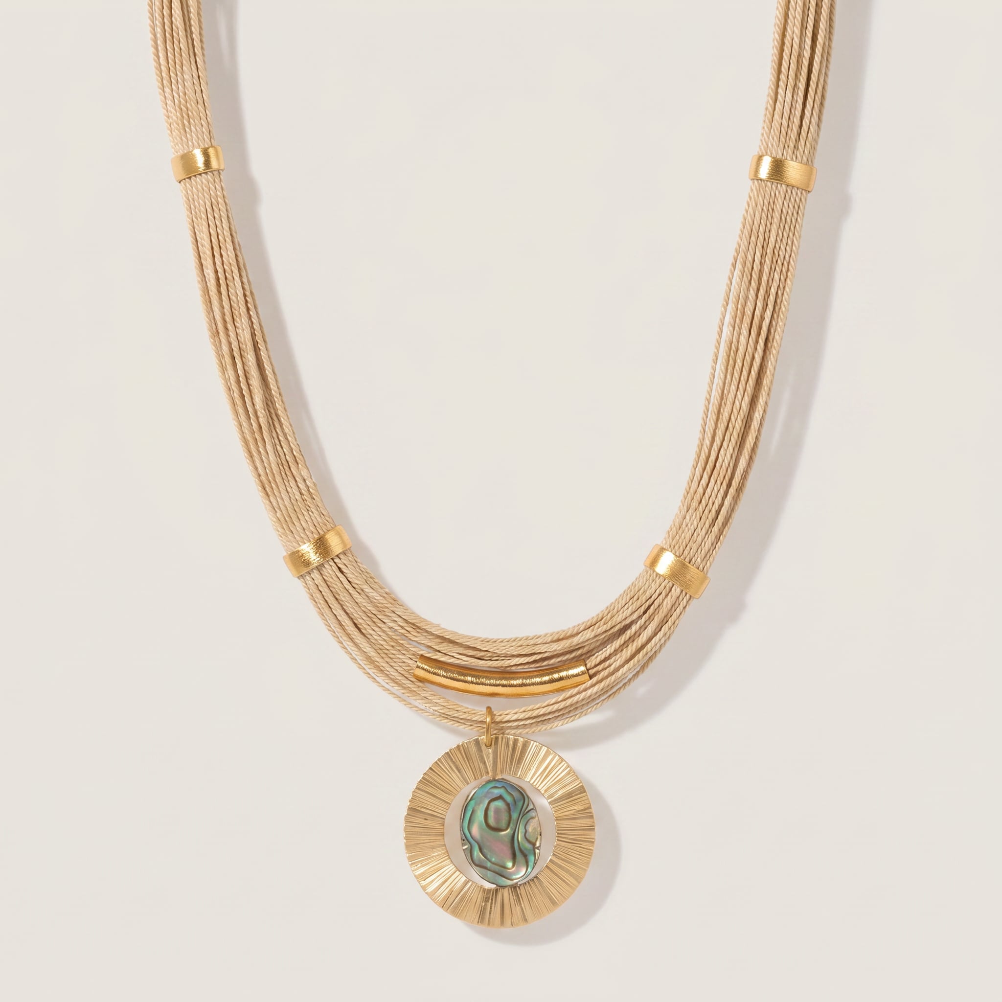 Purplee Store Buriti Artisanal Serelis Necklace on a light beige background