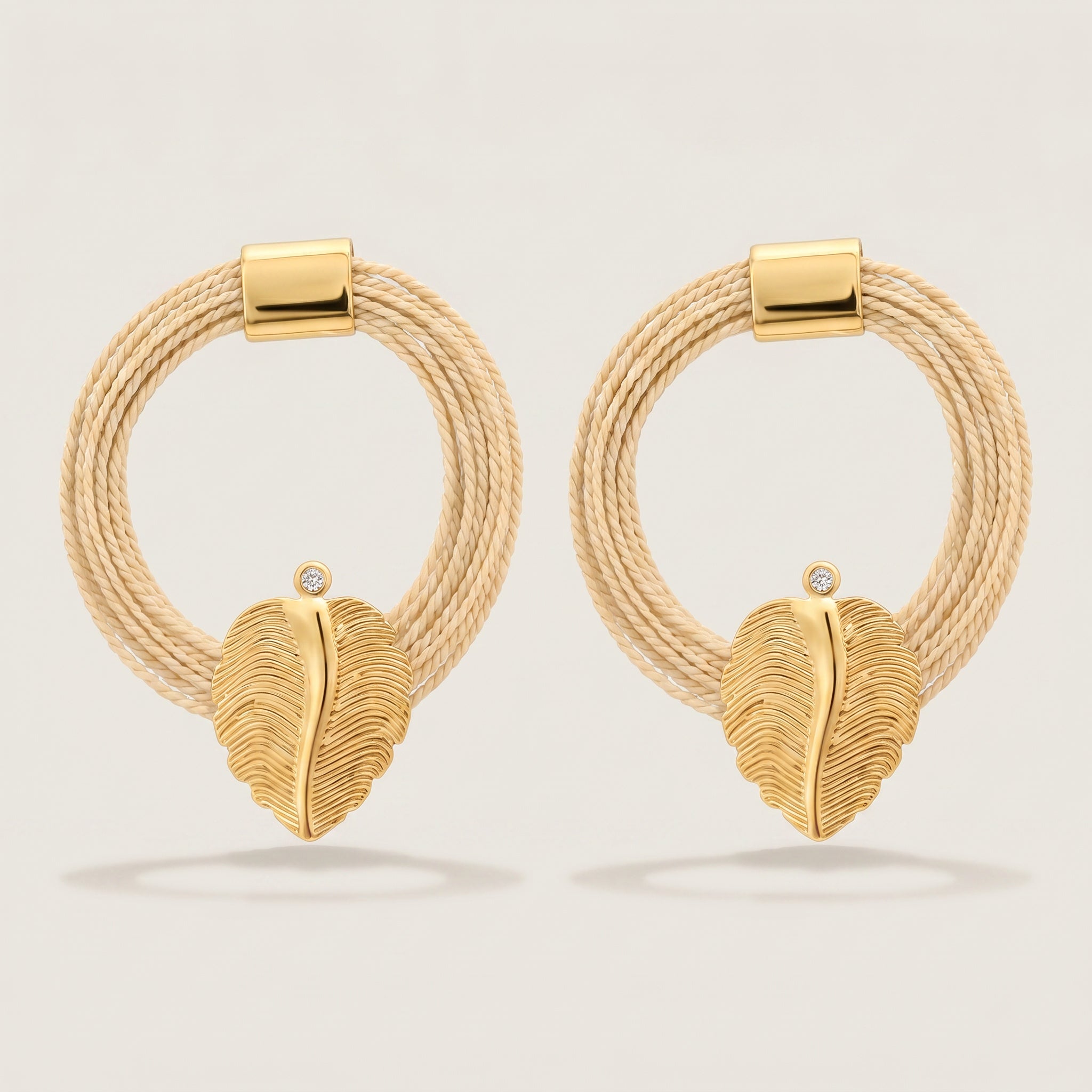 Purplee Store Pair of Buriti Artisanal Zariel Earrings with leaf design on a light gray background