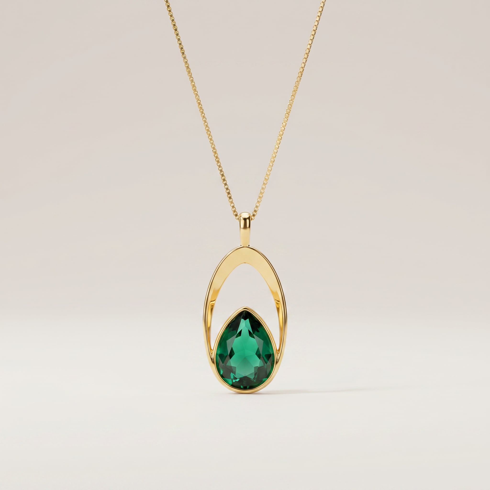 Purplee Store ELAN Emerald Halo Necklace pendant on a light beige background