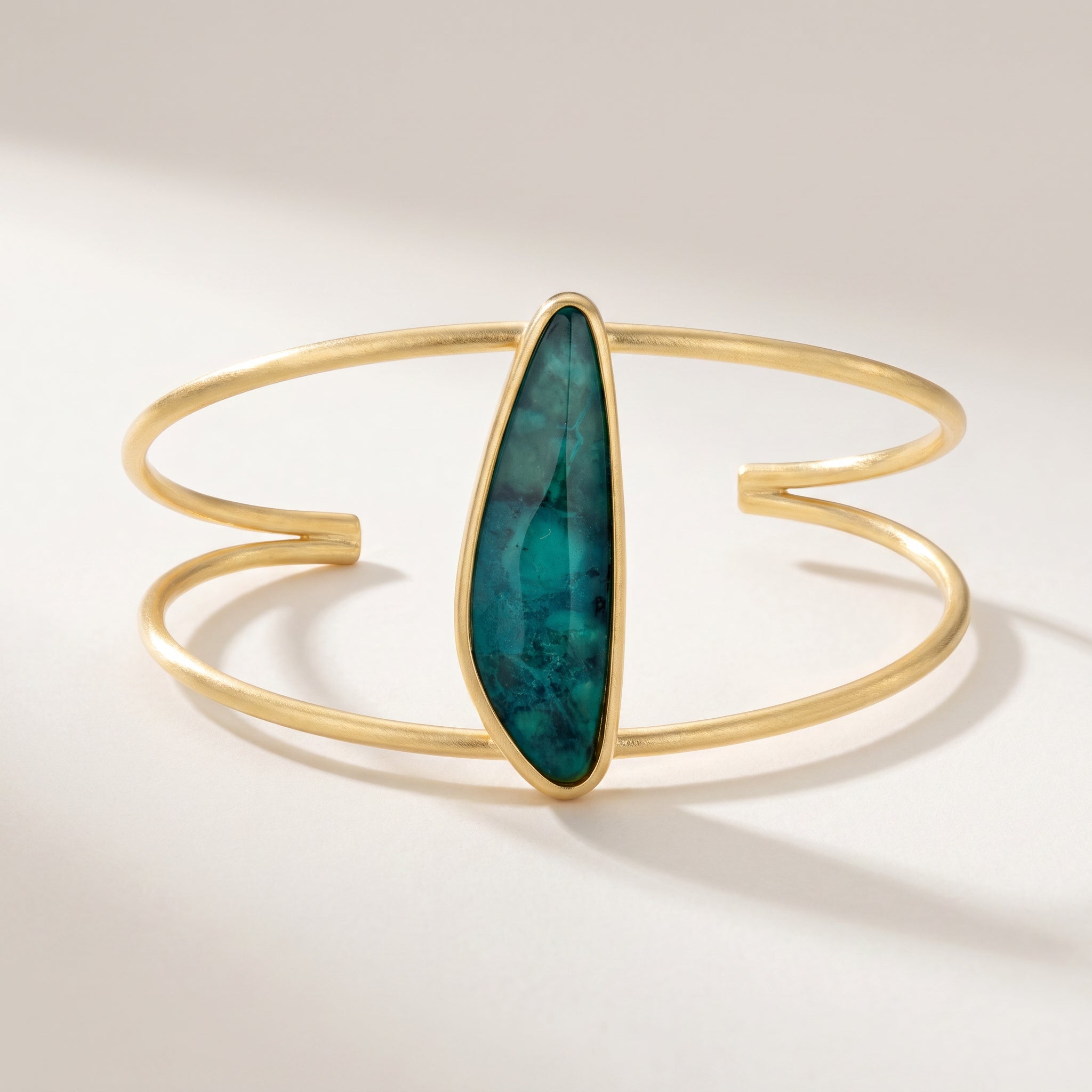Purplee Store ELAN Emerald Sculptural Cuff on a light background