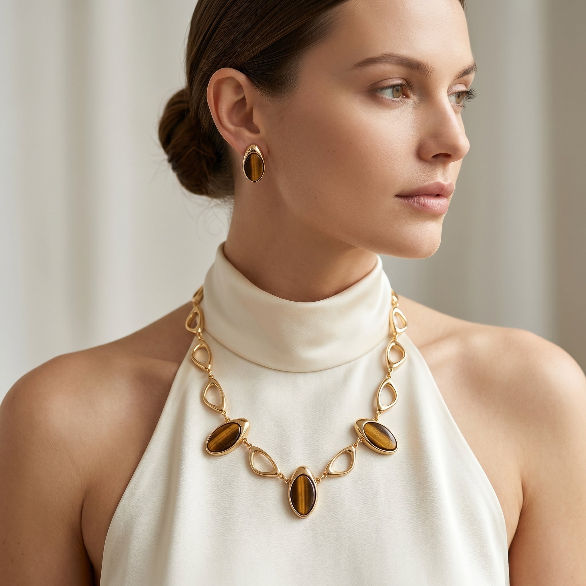 Woman wearing a Purplee Store Earthly Opulence Ethereal Tiger’s Eye Statement Set against a neutral background
