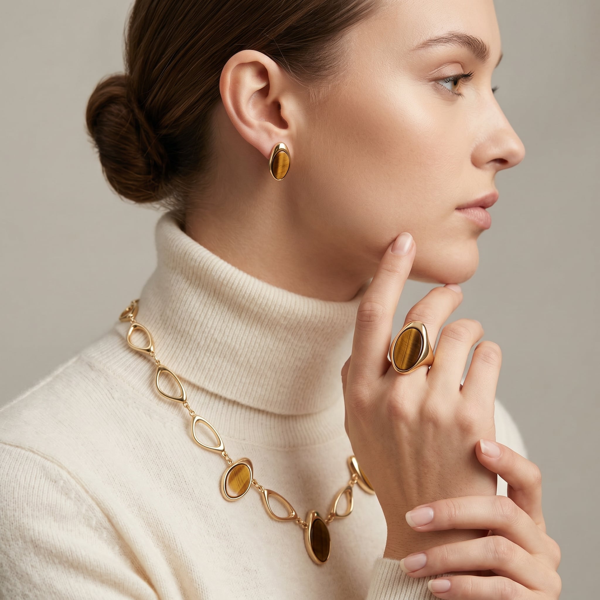 Woman wearing Earthly Opulence Ethereal Tiger’s Eye Statement Set and ring on a neutral background
