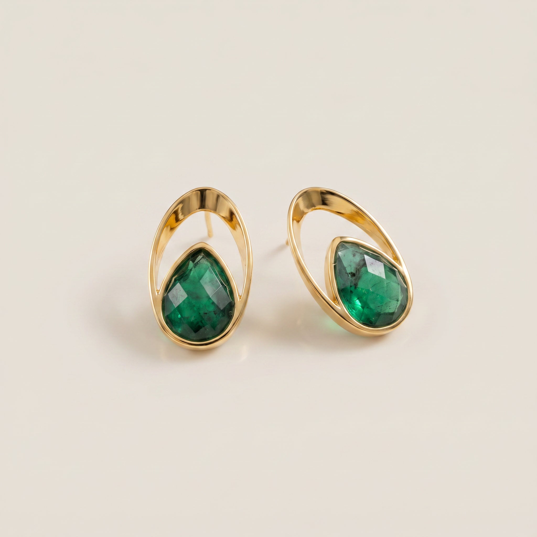 Purplee Store Emerald Orbit Earrings on a beige background
