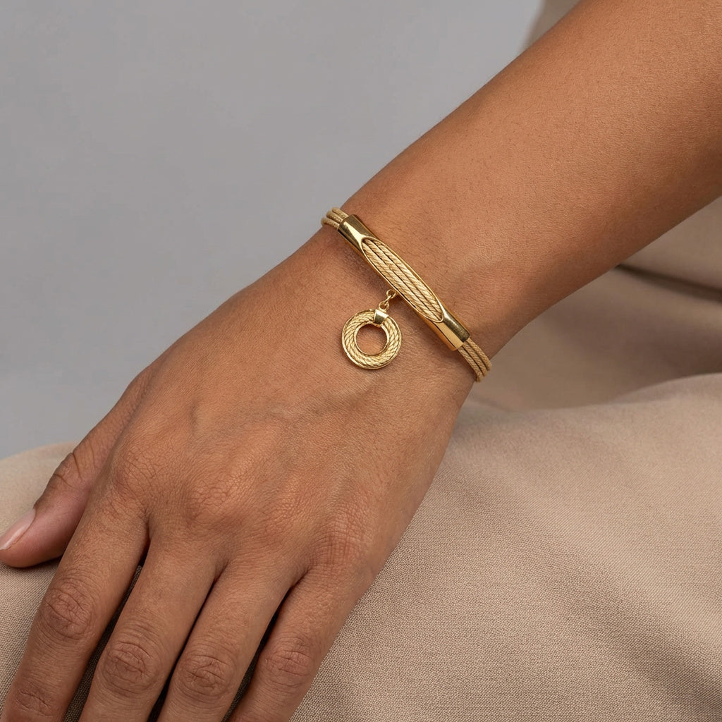 Gold bracelet on a wrist, Handcrafted Adjustable Mandala Isyra Buriti Fiber Bracelet with a neutral background.| Purplee Store