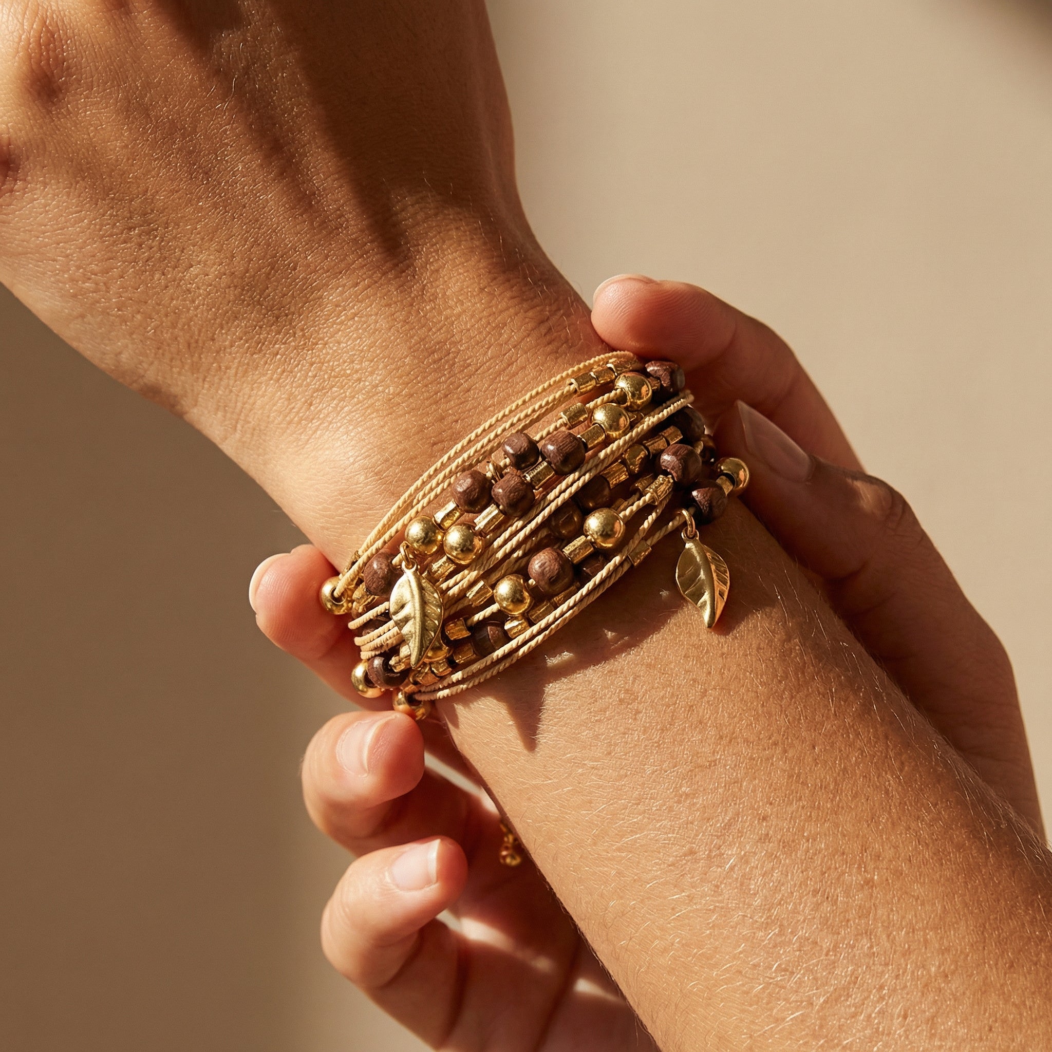 Close-up of a woman using a Handcrafted Buriti Amaris Bracelet with Natural Palm Seed on a neutral background. Purplee Store