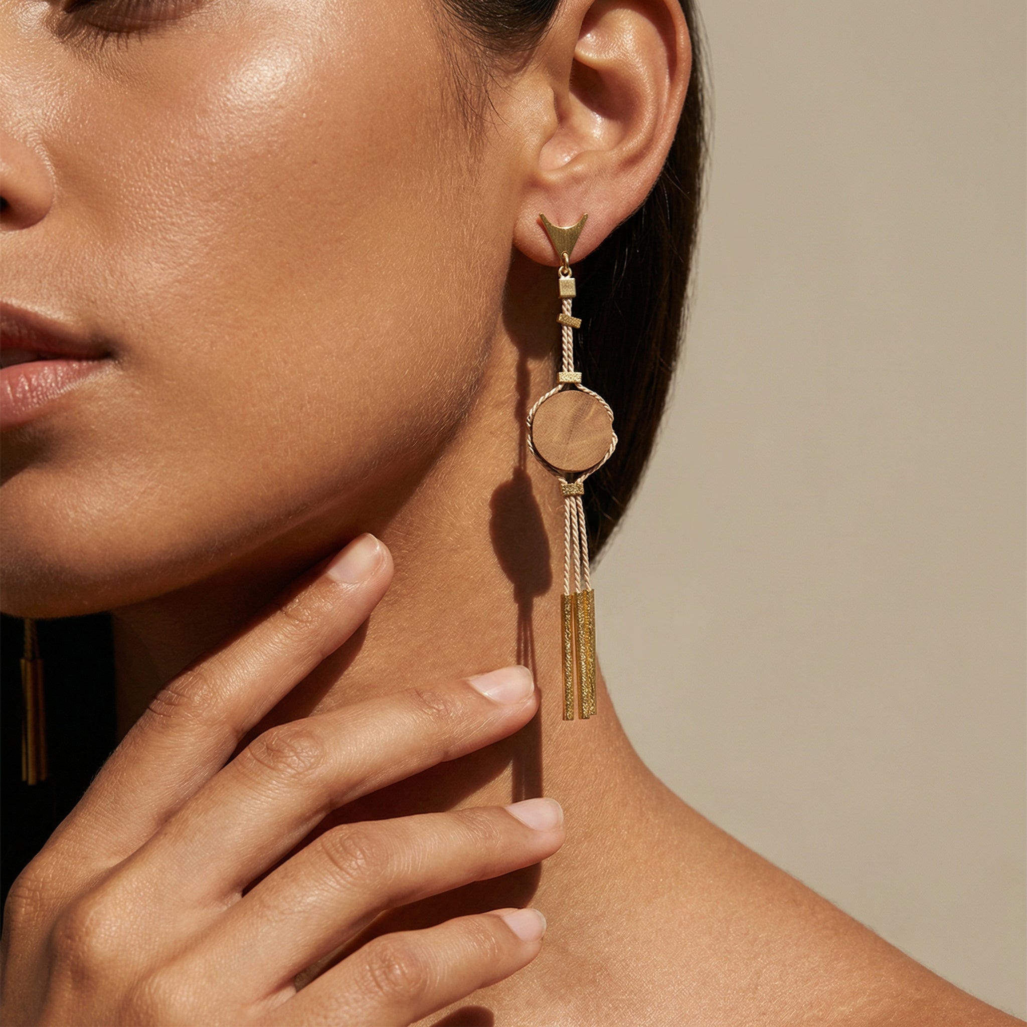 Close-up of a woman wearing a Handcrafted Buriti Amira Earrings with Natural Palm Seeds on a neutral background. Purplee Store
