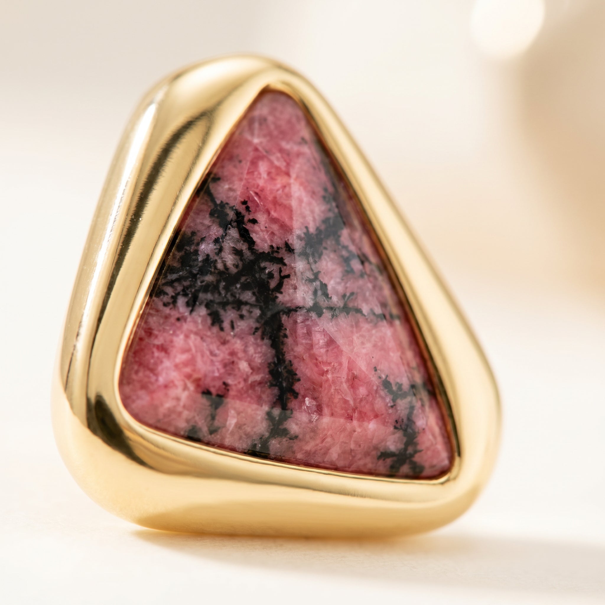 Close-up on a Purplee Store ICON Eclipse Rhodonite Statement Earrings on a light background