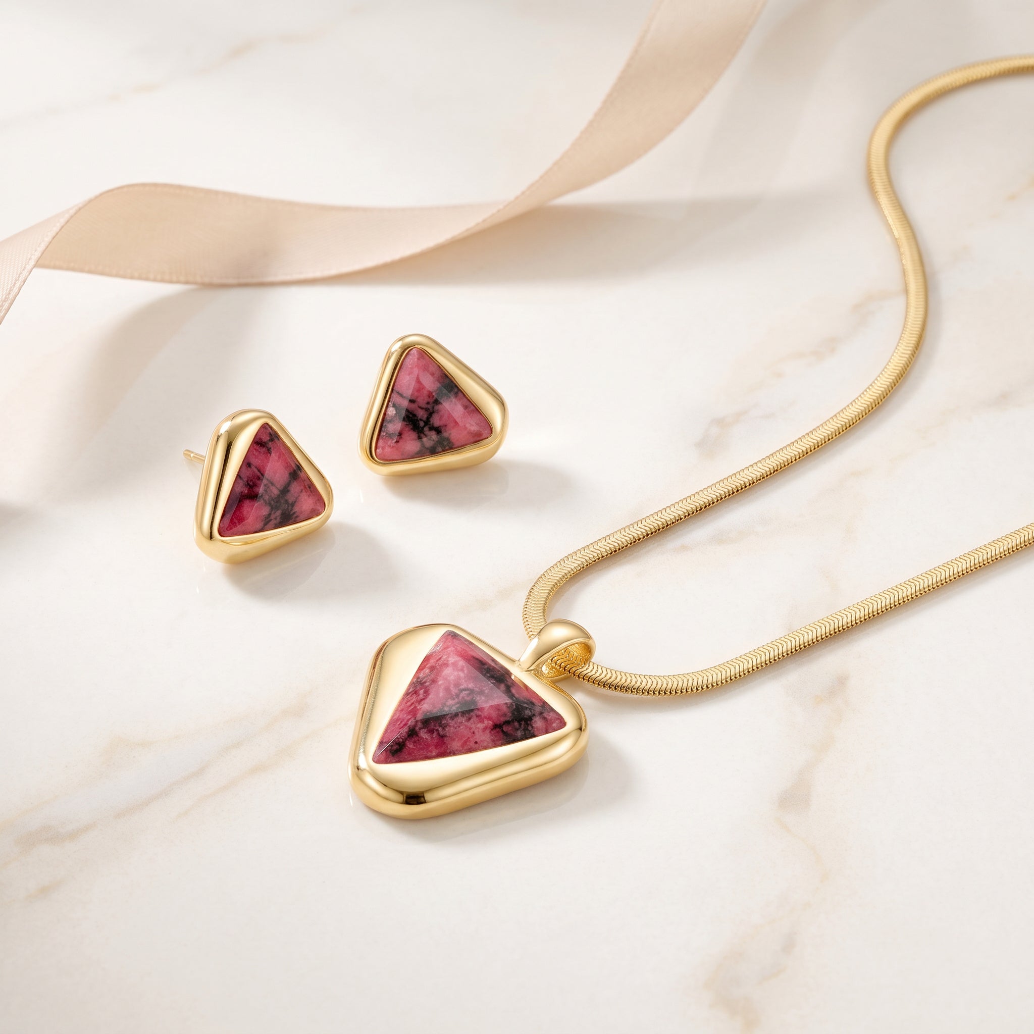 Jewelry set Purplee Store ICON Eclipse Luxury Rhodonite Pendant Necklace on a marble surface.