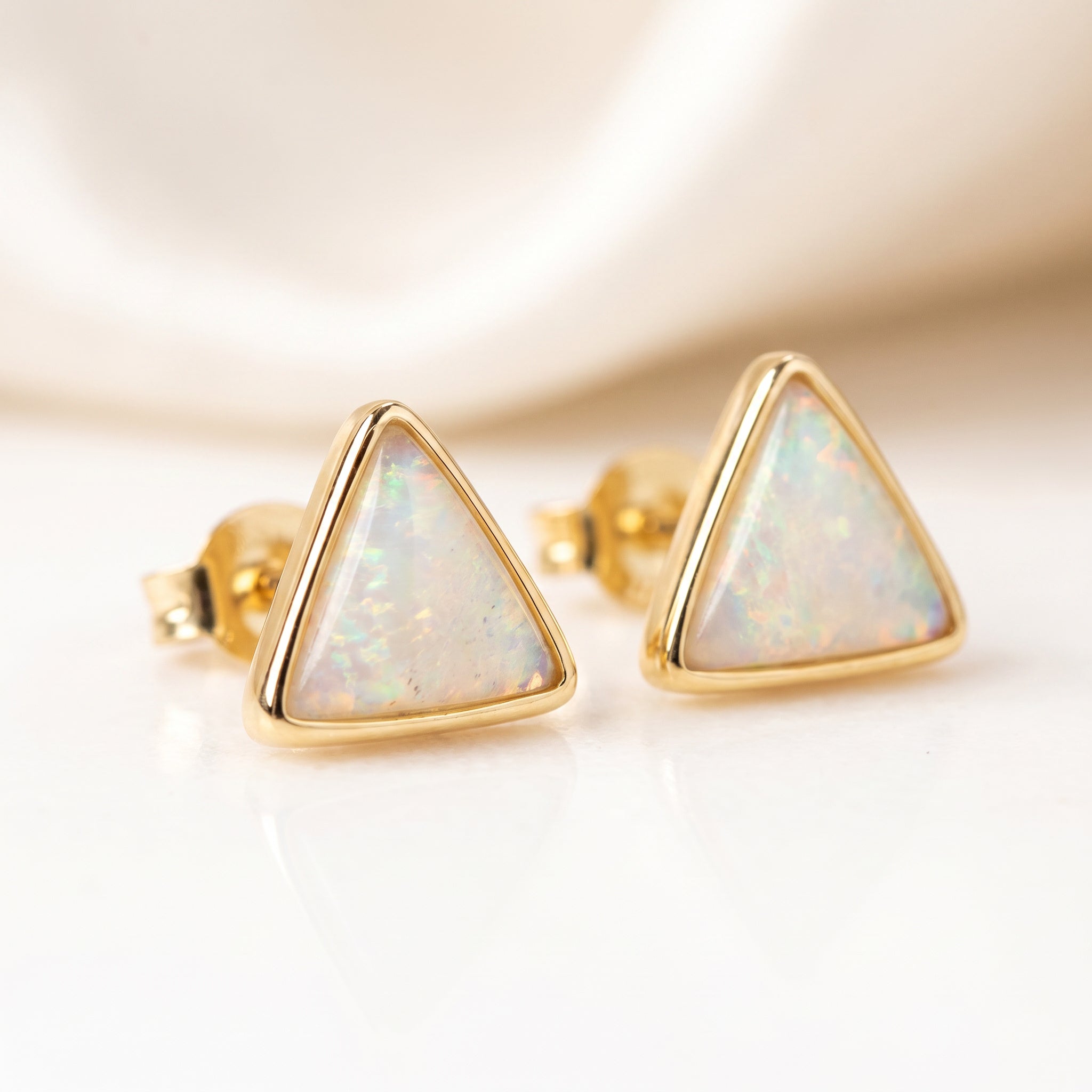 Purplee Store ICON Luxury Triad Opal Earrings setting on a light background