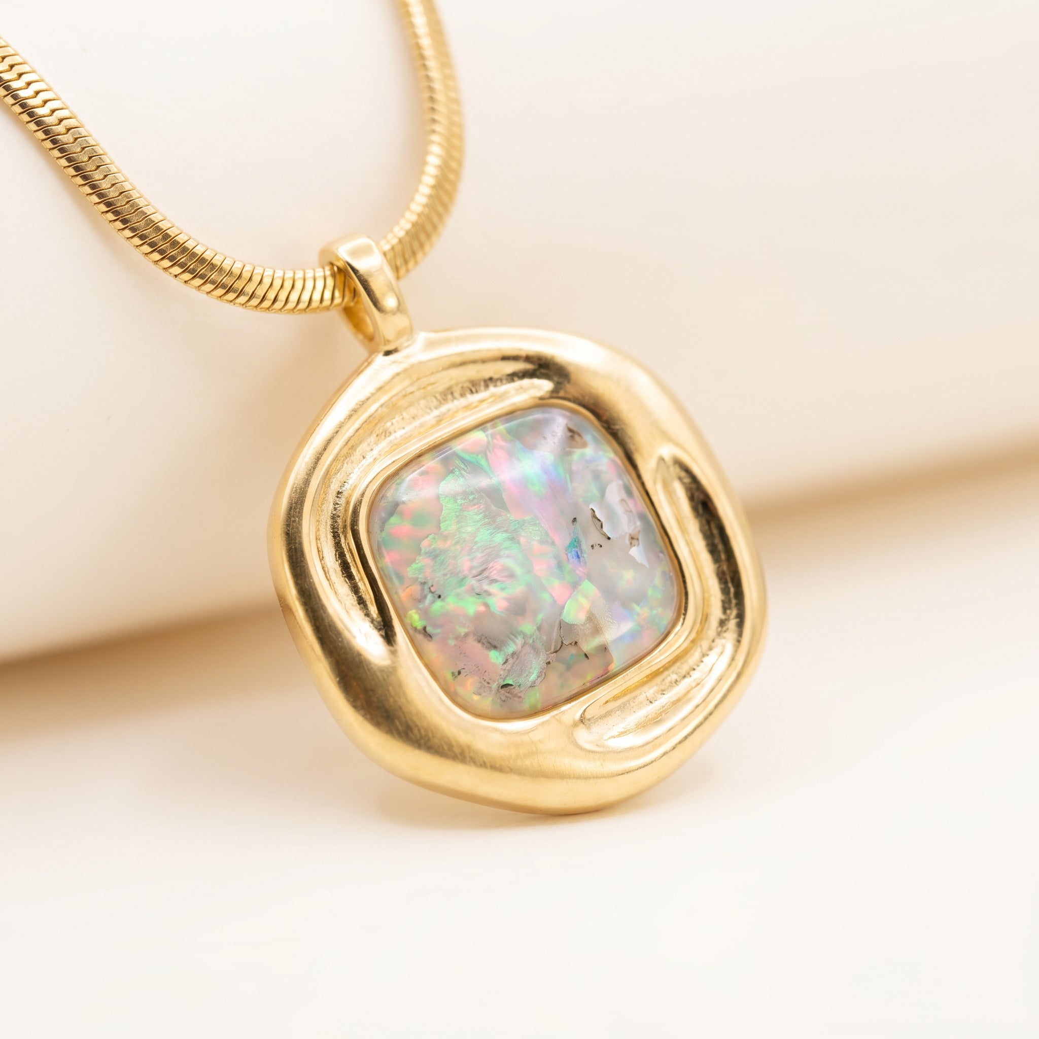 Close-up of Purplee Store ICON Nautilus Opal Architectural Necklace on a light background