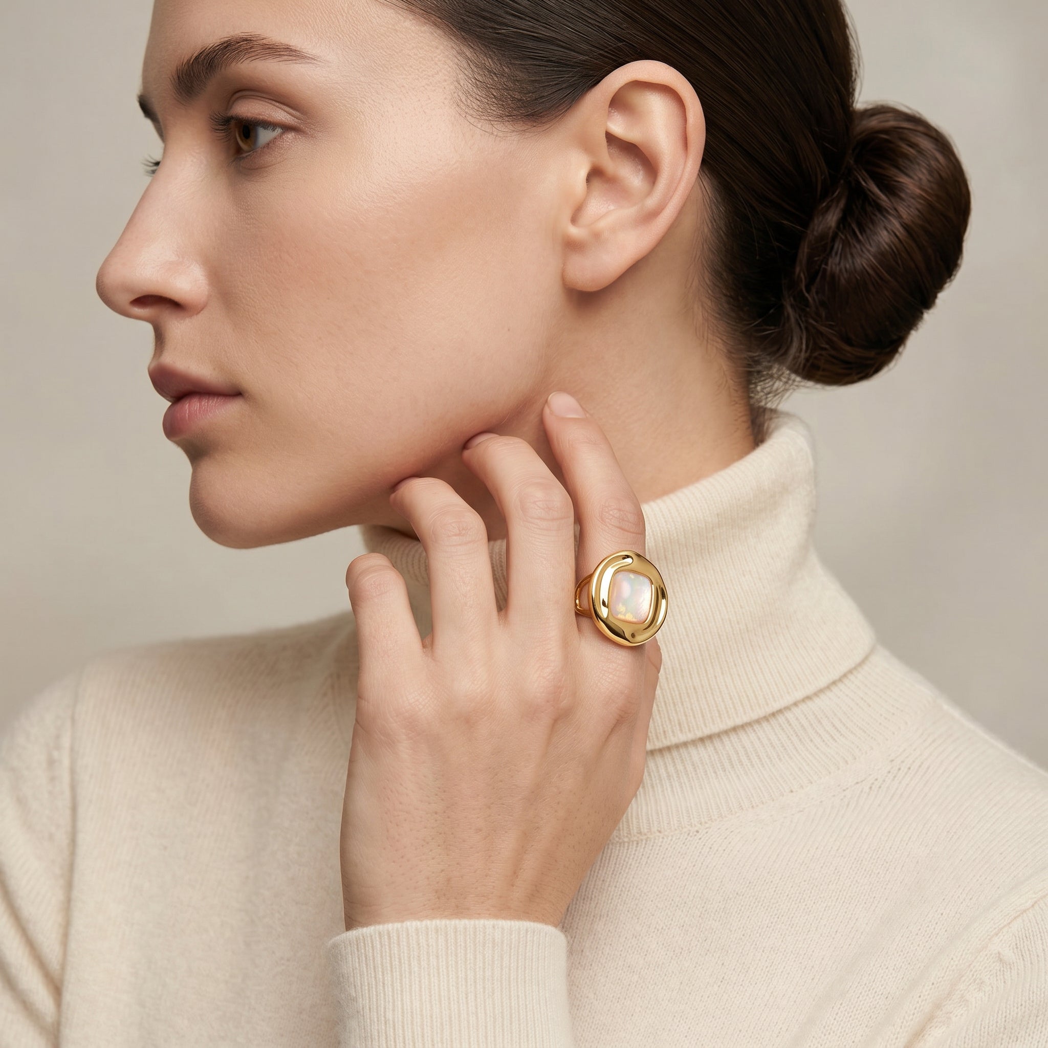 Woman wearing a Purplee Store ICON Nautilus Opal Premium Ring with a beige background