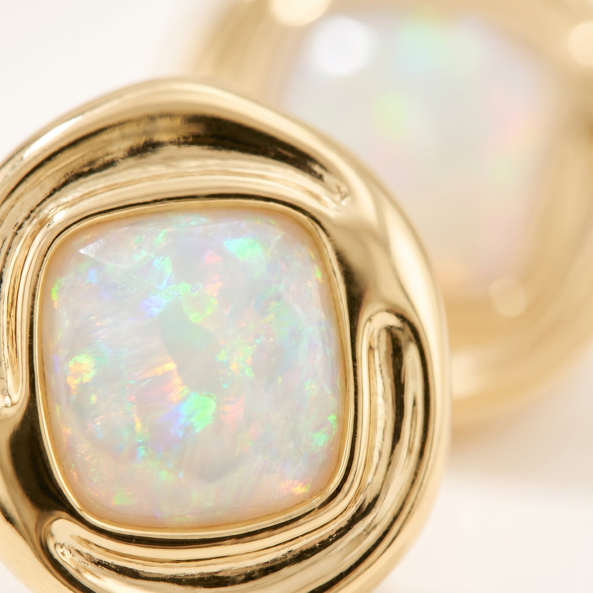 Close-up of a Purplee Store ICON Nautilus Opal Statement Earrings