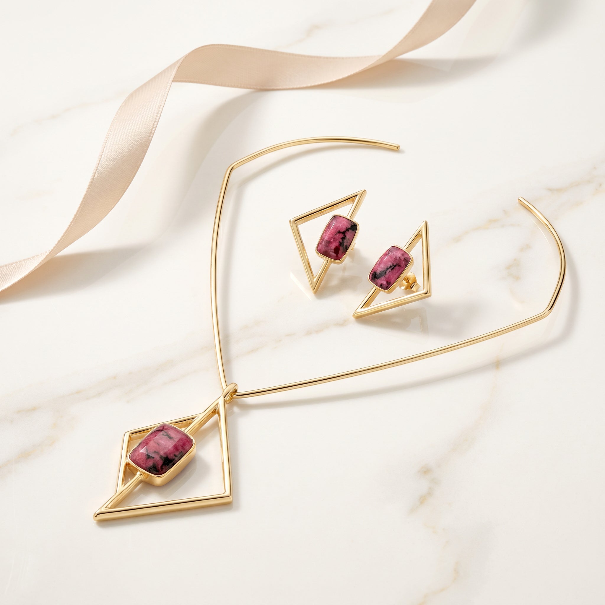 Purplee Store ICON Vertex Rhodonite set on a marble surface