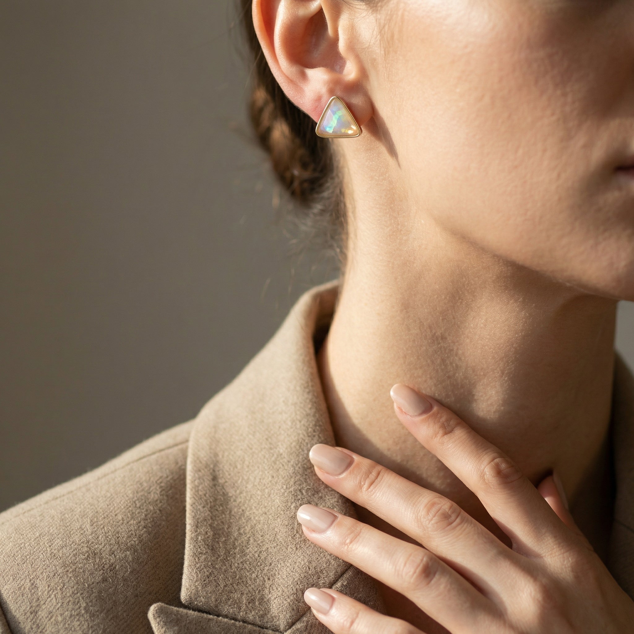 Close-up of a woman wearing a Luxury 24K Gold Plated Opal Earrings - Triad Designer against a neutral background. Purplee Store