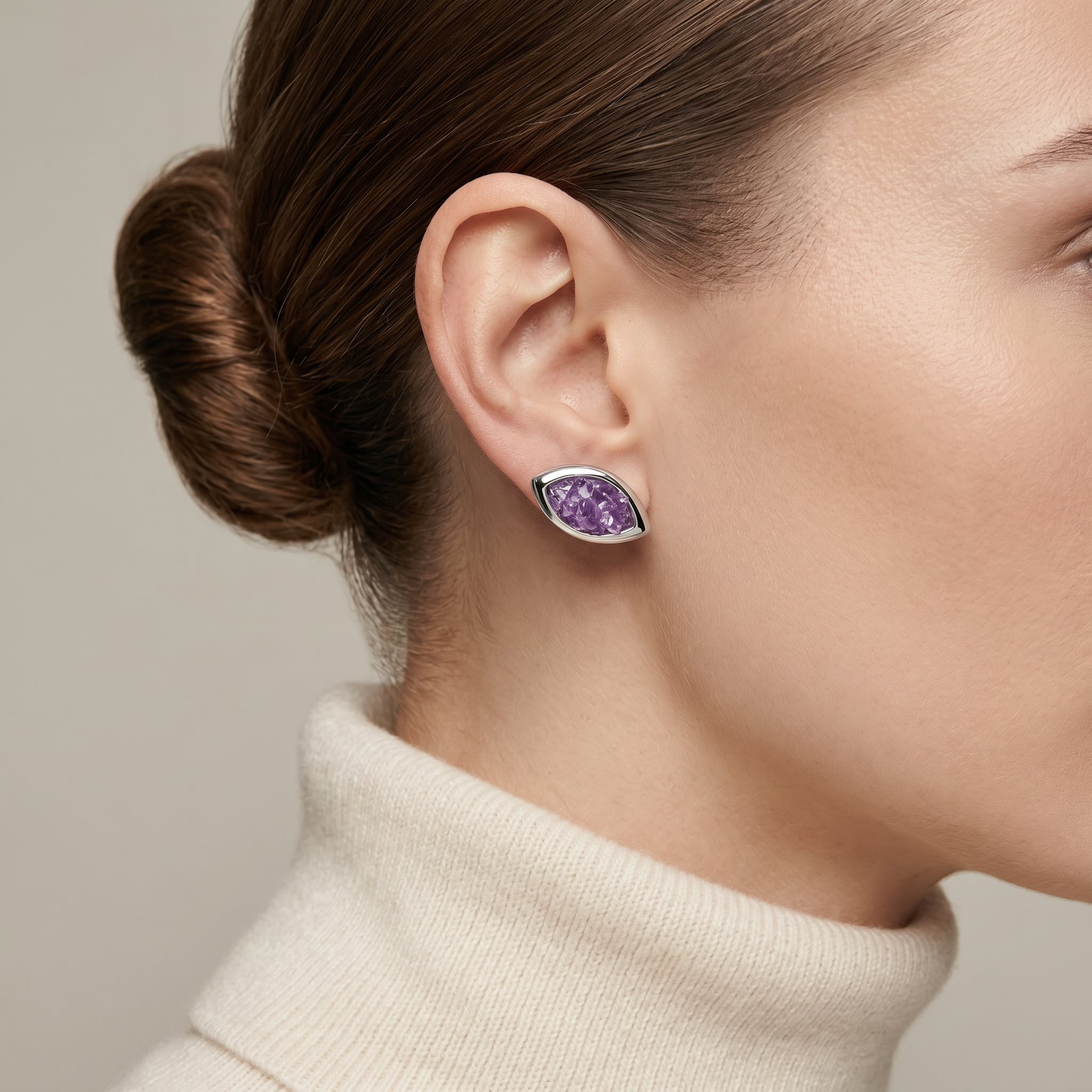 Close-up of a woman wearing a PIORELLE Amethyst Birthstone Earrings against a neutral background| Purplee Store