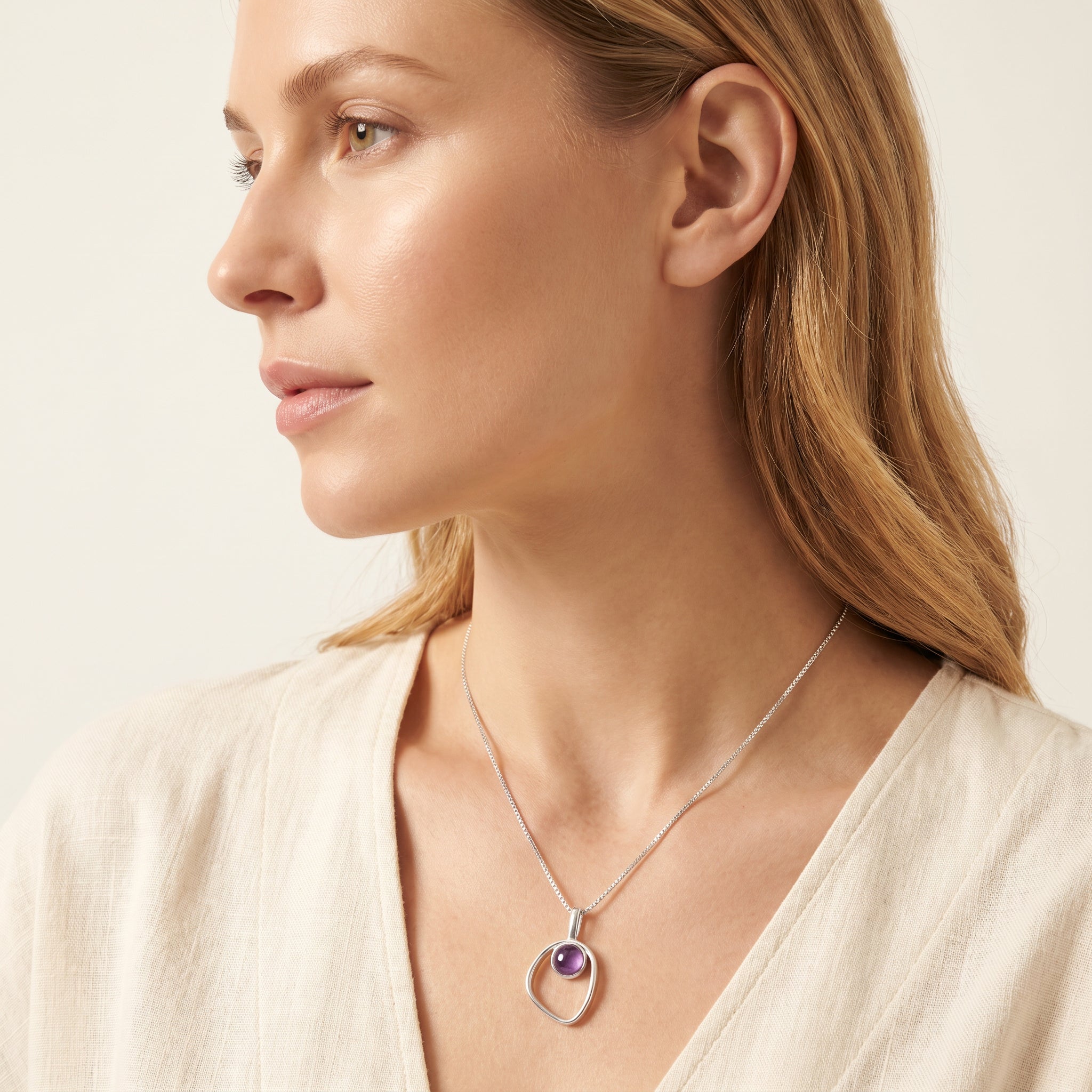 Woman wearing a Purplee Store PIORELLE Organic Amethyst Necklace on a plain background