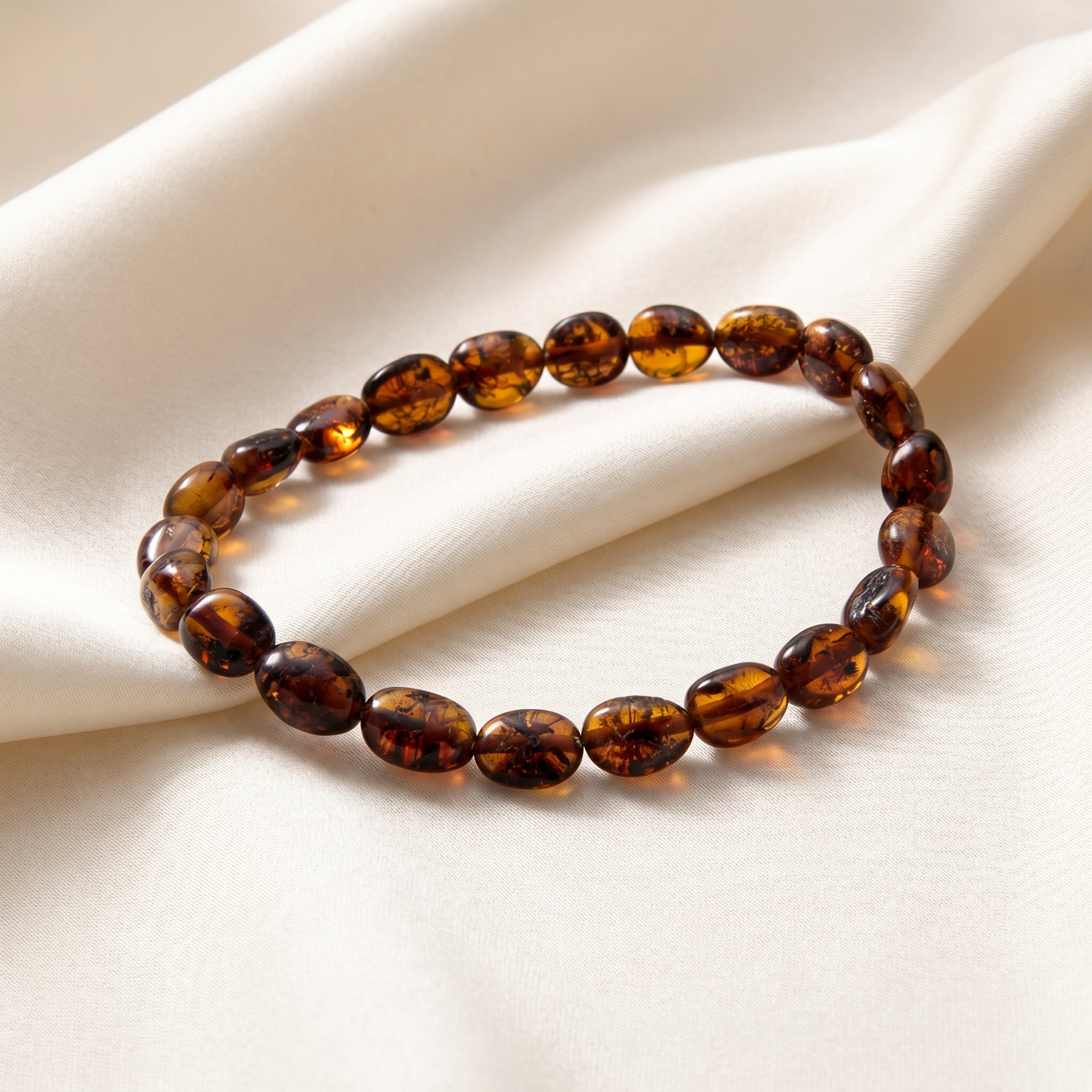 Amber Cognac Energy Olive Bracelet|Purplee Store on a beige fabric background