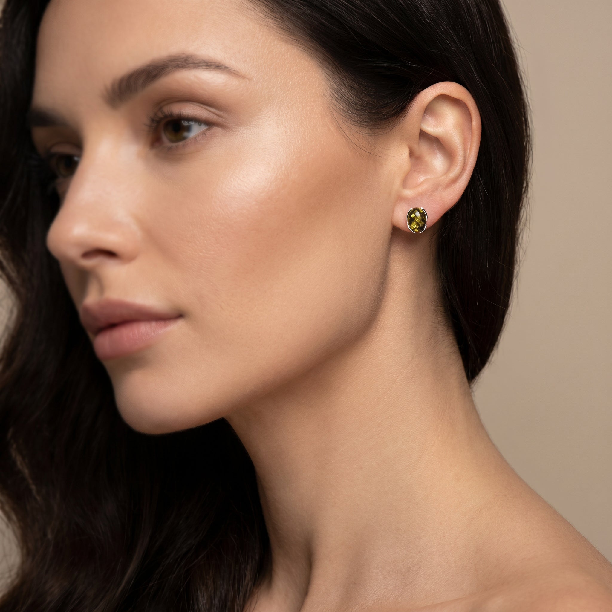 Close-up of a woman wearing Amber Glow Forest Green 925 Silver Drops|Purplee Store against a neutral background